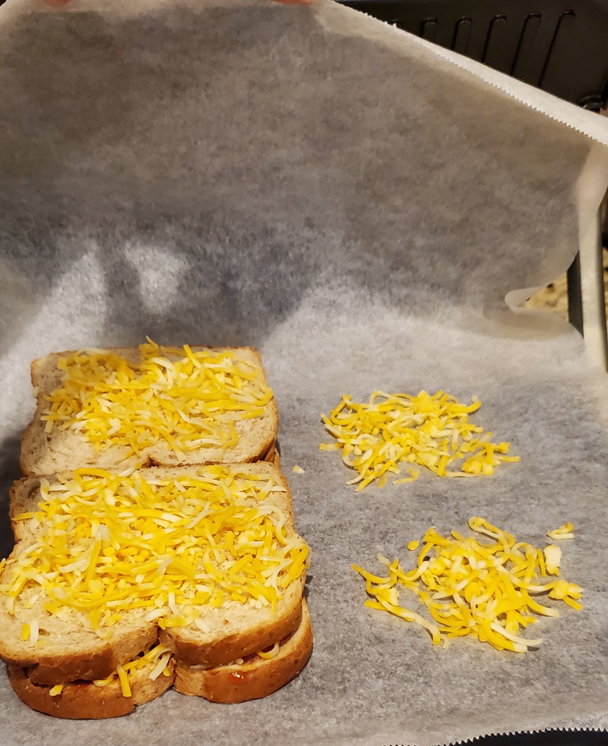 place parchment paper on grill and spread cheese